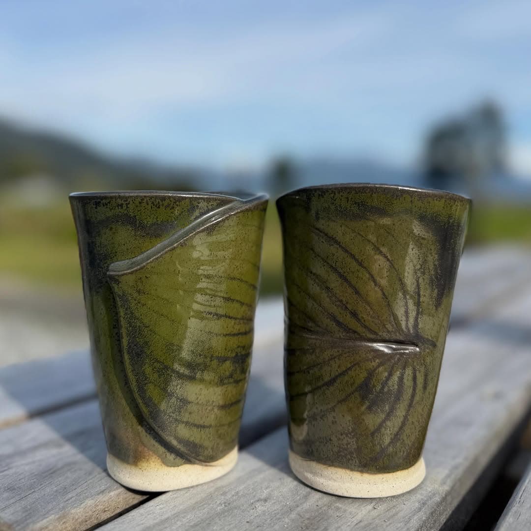 Two leaf pressed tumblers in olive green glaze