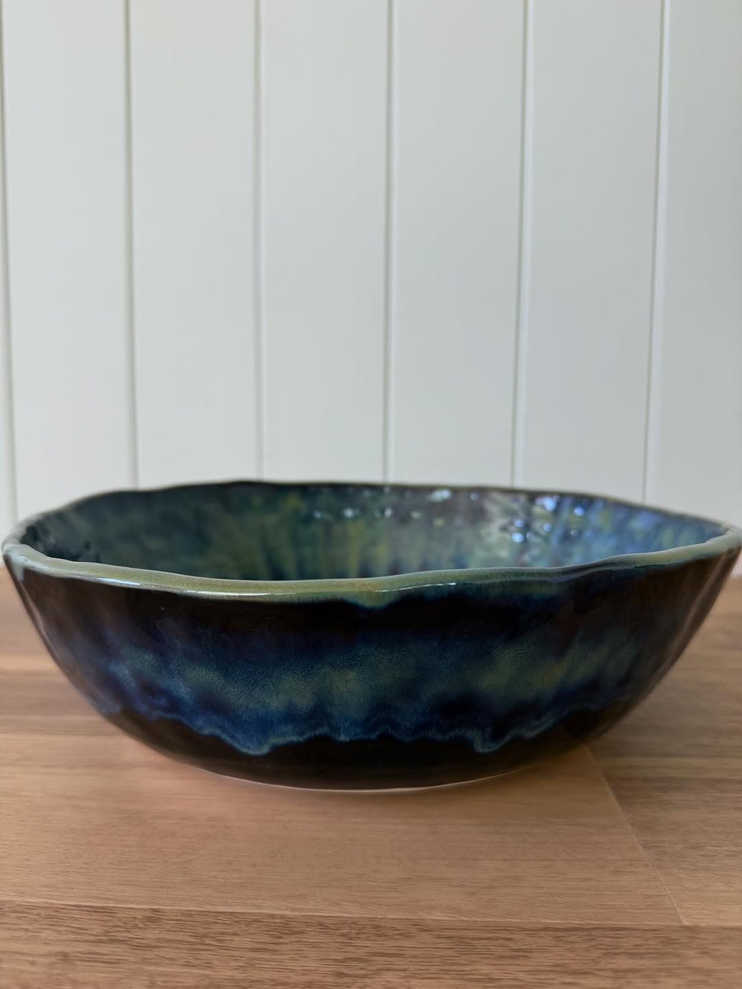 Hand thrown serving bowl in deep blue and green drip glaze