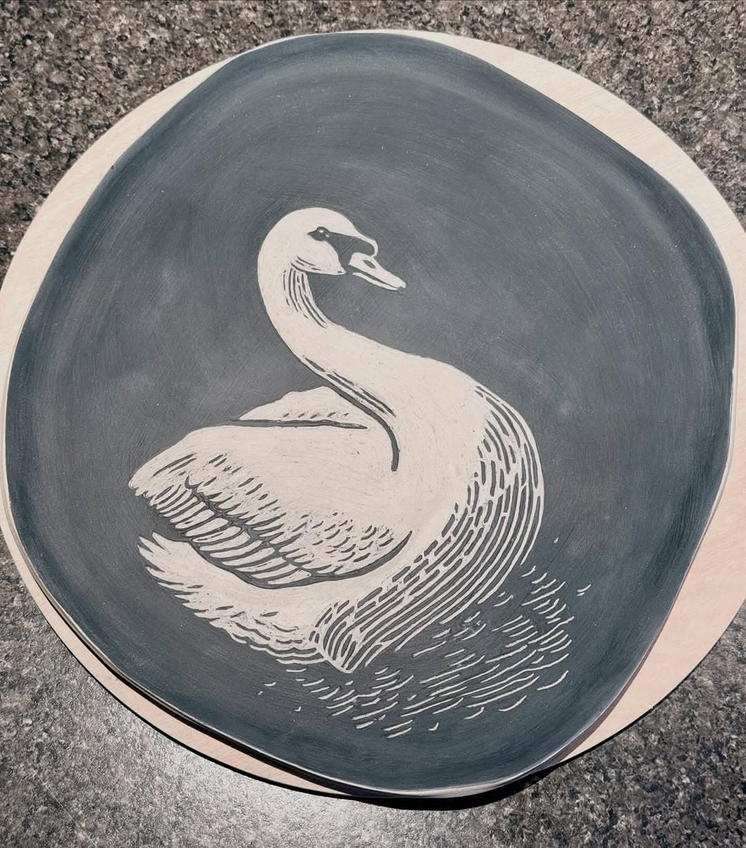 Swan platter being carved through grey slip